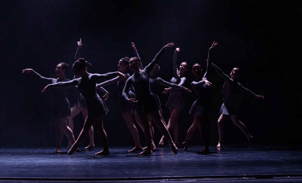 Ballet dancers in costume on stage.