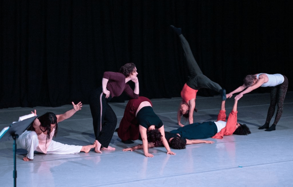 Dancers posed in different interlocking shapes. 