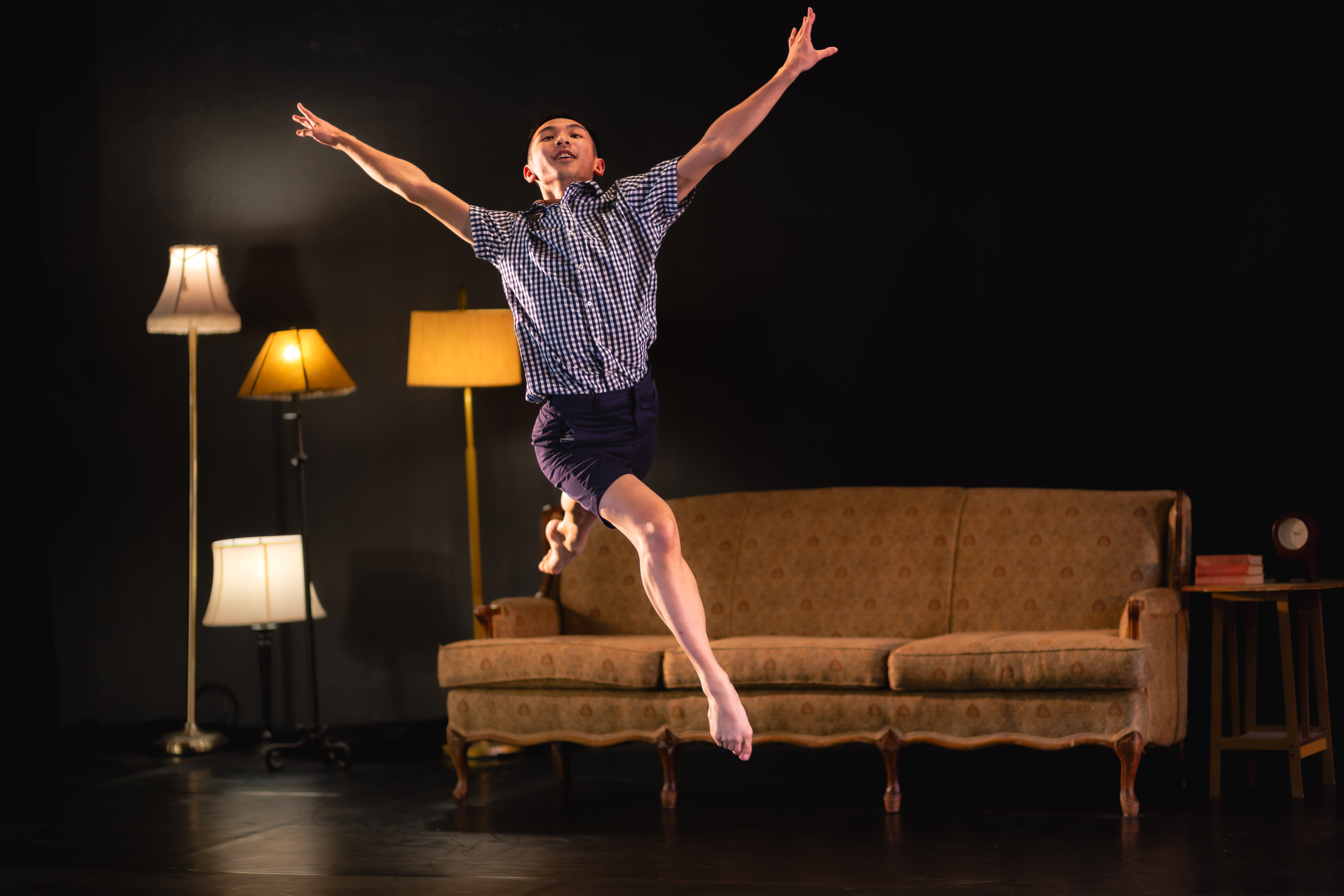 Young looking male dancer springing into the air with joy and ease.